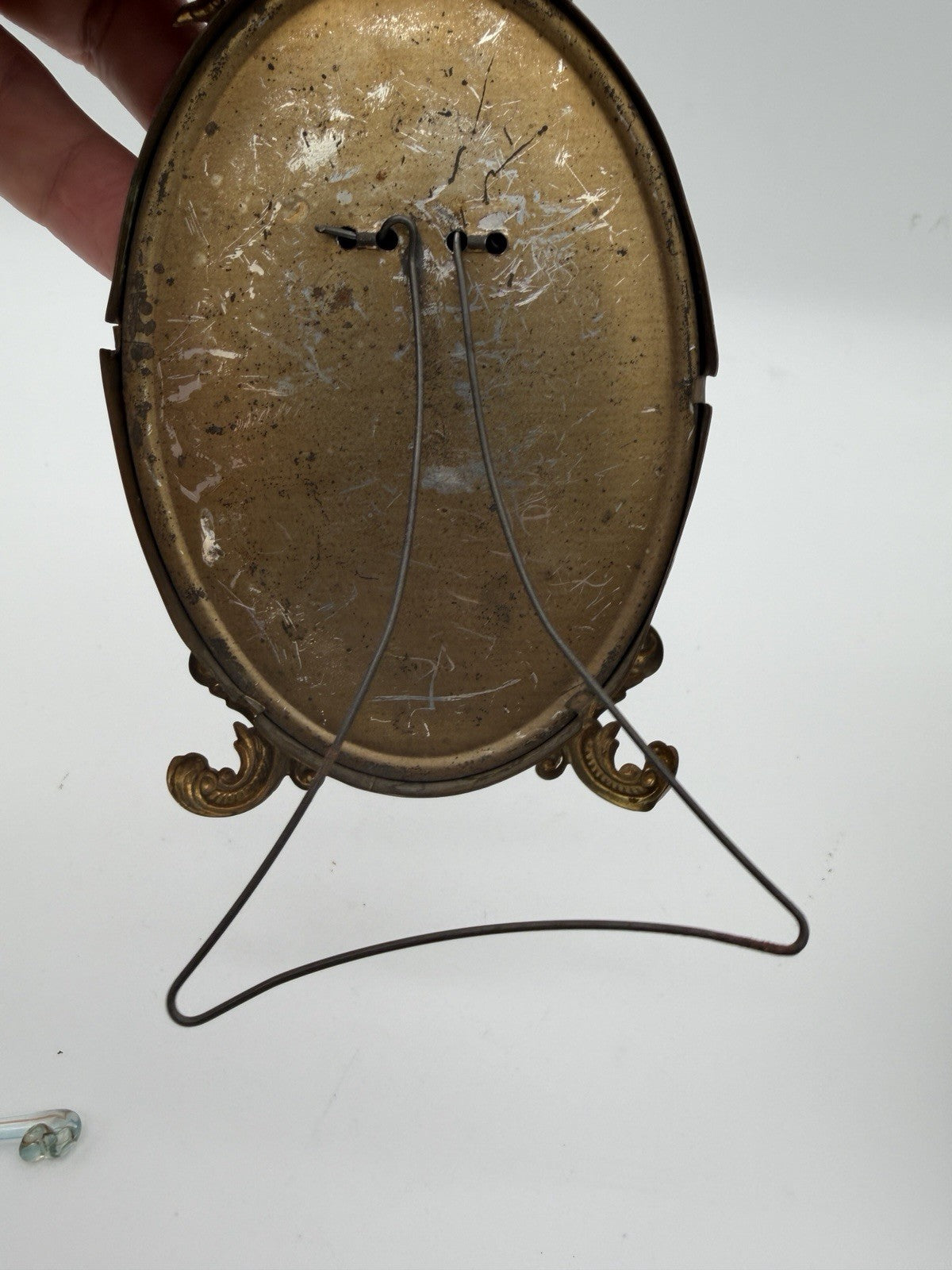 Antique oval picture frame ornate brass scrolling top ribbon accent