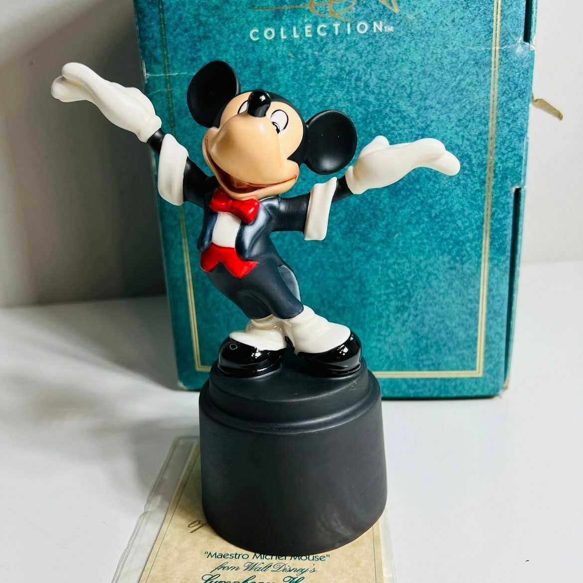 a figurine of a mickey mouse on top of a box