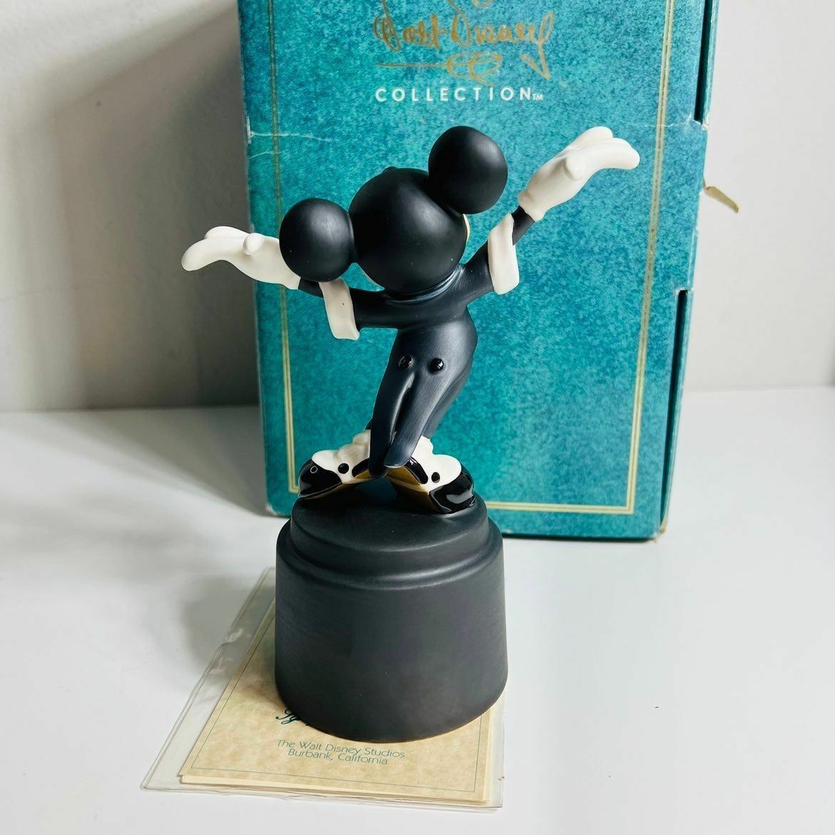 a figurine of a mickey mouse on a black base