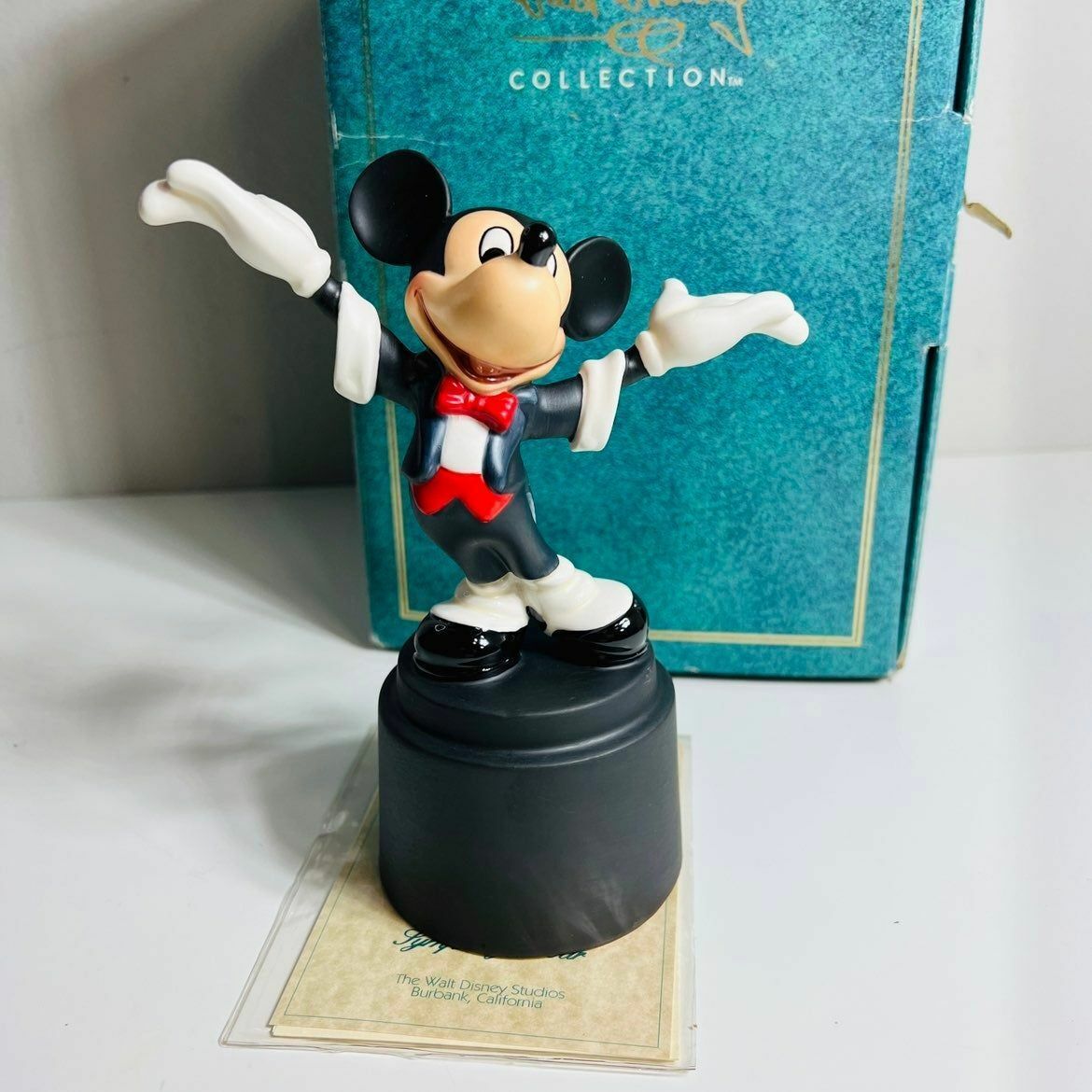 a figurine of a mickey mouse on top of a box